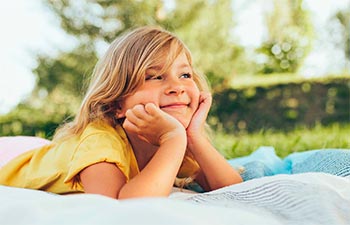 Happy girl relaxing in a park on a sunny day.