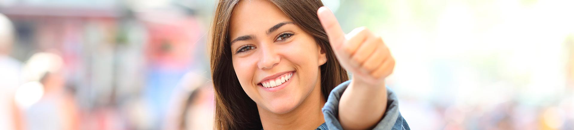 Happy teenage girl showing her thumb up.