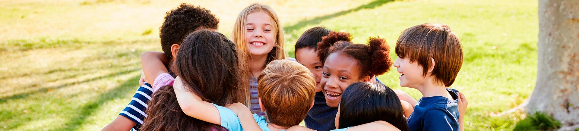 Multi-cultural group of children in a park.