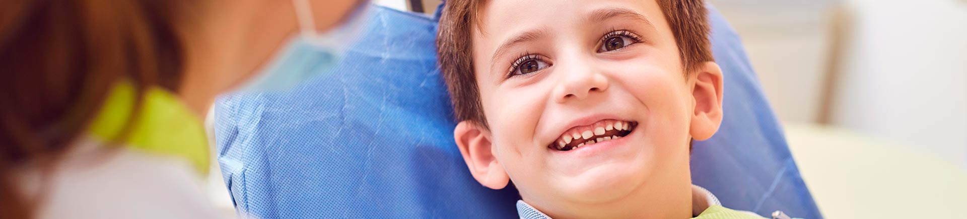 Relaxed joyful little boy in a dental chair during a dental appointment.