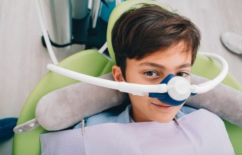 Little boy getting sedation before dental treatment.